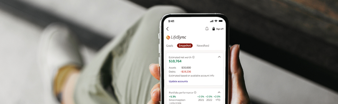 Hand holding mobile device displaying Lifesync investment account info
