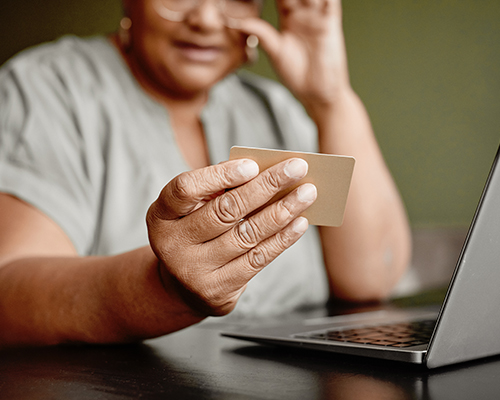 Older adult looking at gift card with questioning look