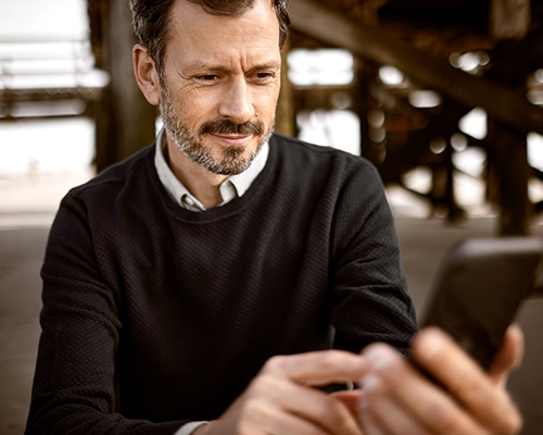 Man with cell phone looking confused