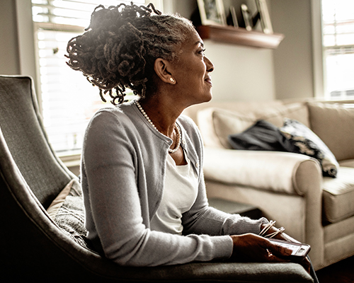 Woman sitting looking thoughtful