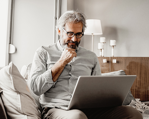 Man looking at a laptop with a concerned look
